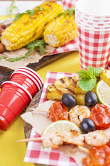 Different fruits and vegetables on grilled and shrimp. Yellow background. Summer dinner. Free space for text. copy space. flat lay.