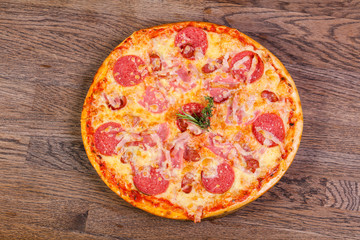 Pizza with ham and sausages