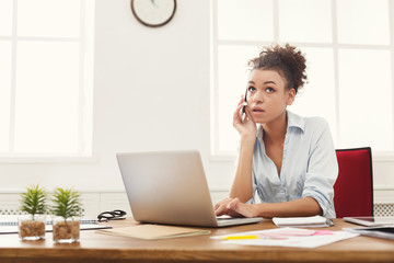 Concentrated business woman talking on phone