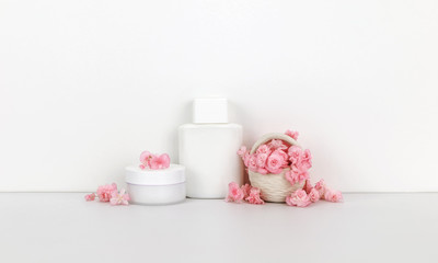 Cosmetics mockup with pink flowers, bottle contain