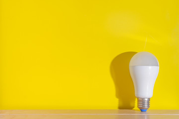 Light bulb on yellow background with copy space.Bright and fresh idea concept.