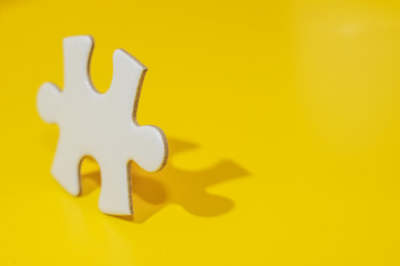 A piece of blank white puzzle on yellow background with copy space.Education and business background concept.