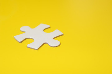 A piece of blank white puzzle on yellow background with copy space.Education and business background concept.