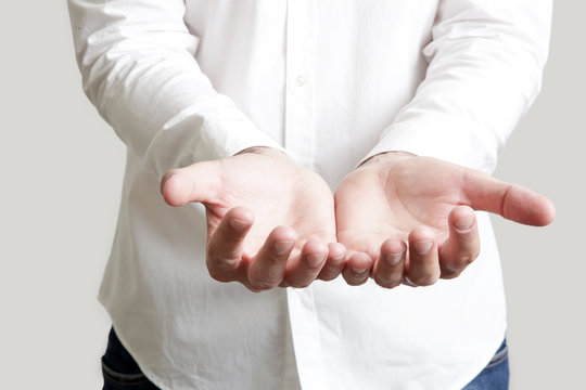 Close up view of businessman open hands, isolated studio photography. Empty hand with copy space.