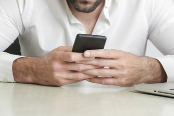 Close up view of mobile phone in hands, studio shot