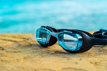 Fototapeta na wymiar Blue diving glasses on the beach