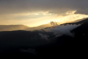 Spectacular light during sunset in the mountains. Dramatic clouds