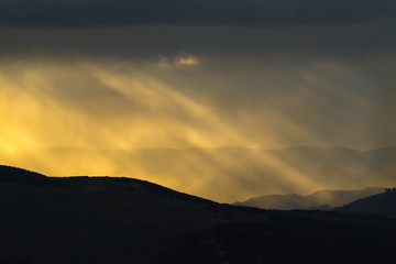 Spectacular light during sunset in the mountains. Dramatic clouds