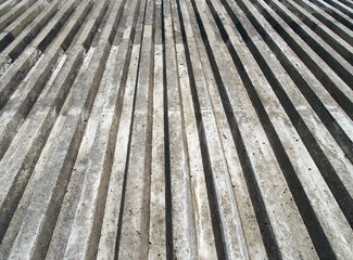 cast concrete with vertical ribbed texture with a converging view in sunlight and shadow