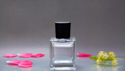A bottle of perfume rose petals and linden flower