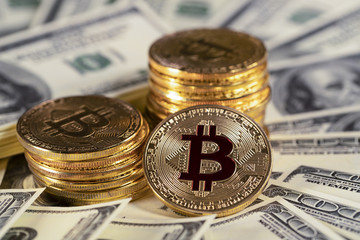Pile bitcoin btc bit-coin lie on hundred-dollar bills of United States. Mining cryptocurrency.