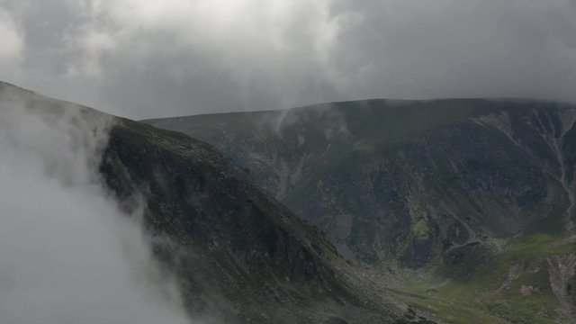 Time lapse of moving clouds in the mountains. Sunny summer day