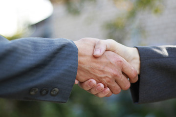 Business partnership handshake concept. Two coworkers handshaking process work