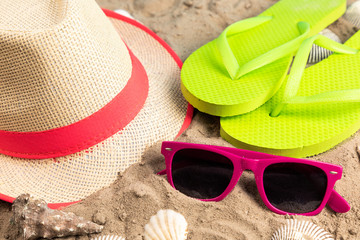 flip flops with sunglasses and strand hat