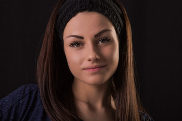 Studio portrait of young beautiful woman posing on black background