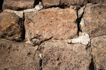 Detail of an old wall with bricks and cement