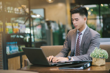 Young businessman sitting at a coffee shop.