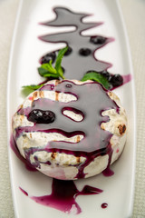baked Camembert cheese with cranberry sauce and mint