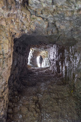 Obraz premium woman walking on the Road of 52 galleries, Veneto, Italy / Strada delle 52 gallerie (Road of 52 galleries) is a military trail built during World War I on the massif of Pasubio (Vicenza, Italy)