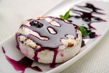 baked Camembert cheese with cranberry sauce and mint