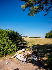 Fly-tipped household furniture, clearance and industrial waste dumped in the welsh countryside
