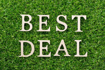 Wood alphabet in word best deal on artificial green grass background