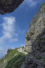 woman walking on the Road of 52 galleries, Veneto, Italy / Strada delle 52 gallerie (Road of 52 galleries) is a military trail built during World War I on the massif of Pasubio (Vicenza, Italy)