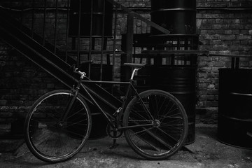 Bicycle at the stairs and barrels
