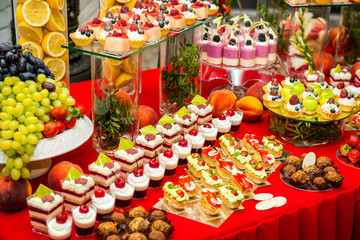 Delicious sweets on candy buffet. Lot of colorful desserts