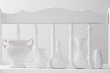 white vases on vintage wooden shelf