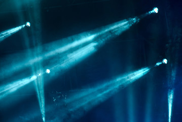 abstract image with rays of colored light in the dark