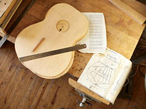 Marking and Pasting of footer and brace to the soundboard of a classical guitar. Production of classical guitar.