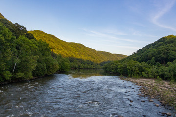 The New River near Thurmond West Virginia, with the sunlight on the mountains.