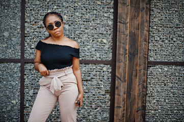 Stylish african american woman at sunglasses posed outdoor.