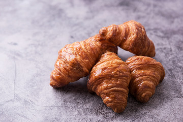 Fresh croissant on a dark table.