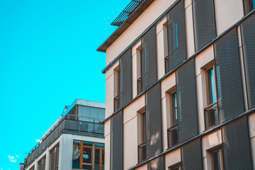 white apartment building with steel lens hood