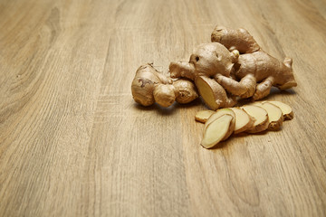 Ginger root sliced on wooden table