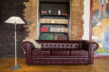 Interior of the room in old style with a leather sofa