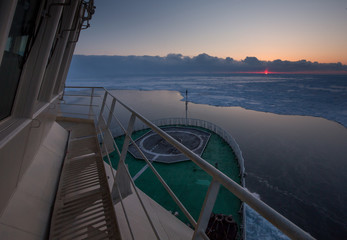 View from the wheelhouse of the Russian icebreaker on the Arctic sunset. Travel across the Kara sea. © Artem Markin