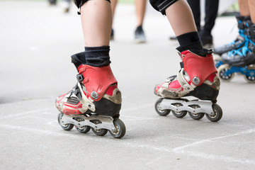Close-up a legs group of men in roller skates are getting ready for the start in competitions on...