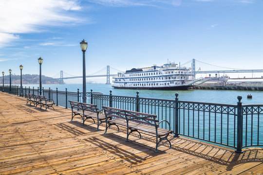 Historic Pier 7 with paddleboat and Bay Bridge, San Francisco, USA