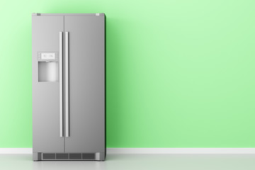 modern fridge in front of green wall