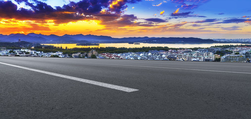 Asphalt road square and river hill under the blue sky