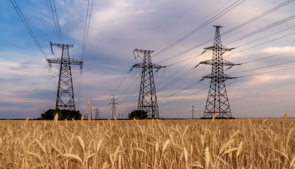 high-voltage power lines at sunset. electricity distribution station .