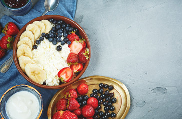 bowl of cottage cheese with berries, bananas and sour cream