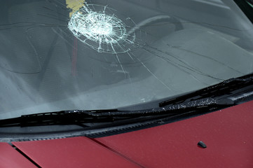 Smashed Car Windshield on Car Driving on Road
