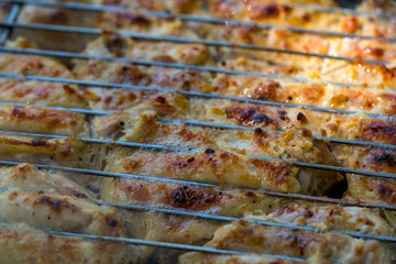 Grilled chicken thigh on the flaming grill