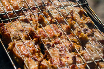 Grilled chicken thigh on the flaming grill