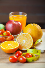 Healthy concept with mixed fruits and vegetables on wooden background