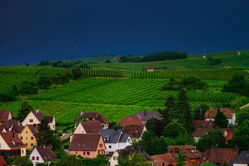 Fototapeta na wymiar Thundery weather befor the storm over the green valley in Alsace, aerial view, vivid colors